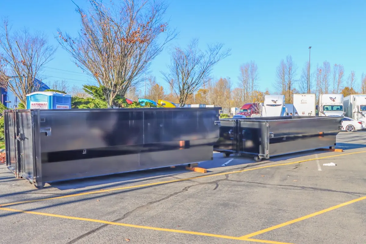 Professional dumpster rental service with roll-off container on residential driveway in Vidalia